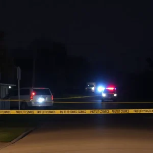Crime scene in Dallas with police tape and emergency lights