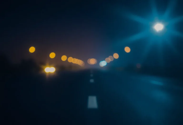 An empty road with blurred headlights, symbolizing the dangers of drunk driving.